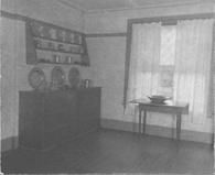 SA0510 - A room interior, showing a drop-leaf table and sideboard with metal ware., Winterthur Shaker Photograph and Post Card Collection 1851 to 1921c